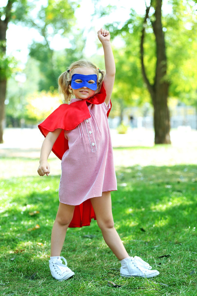 Superhero little girl at the park - Фото, зображення