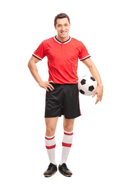 Young soccer player holding a ball - Foto, afbeelding