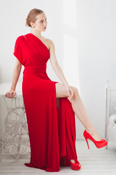 Young girl in a red dress on a white background - Foto, Imagem