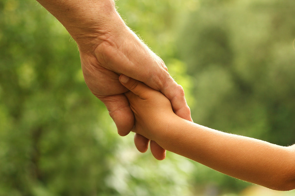 parent holds the hand of  child - Φωτογραφία, εικόνα