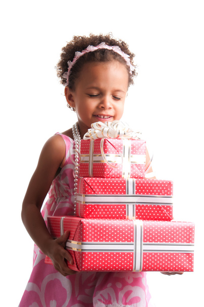 Give presents! Curly mulatto girl with gift boxes in hands on a white background. - Fotografie, Obrázek