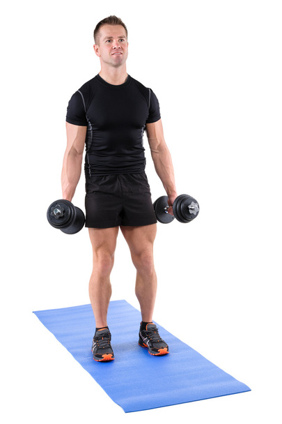 young man shows starting position of biceps curl - Photo, Image