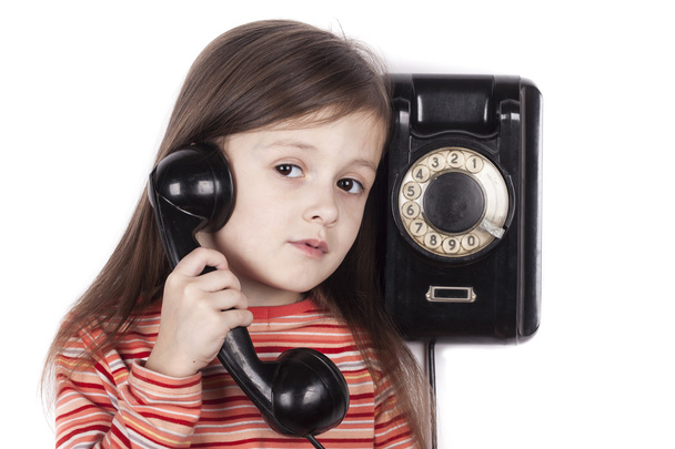 Serious sad child talking on phone isolated, white background - Foto, Imagen