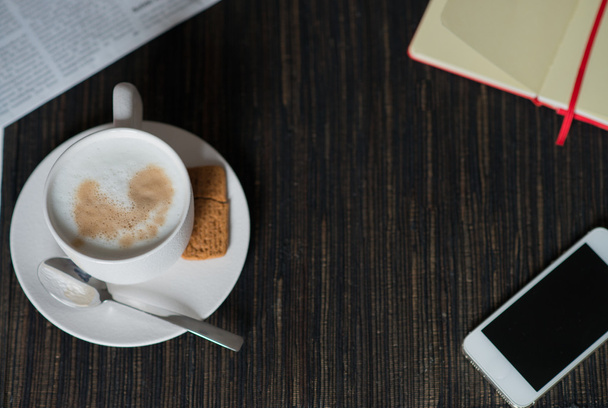 notebook, morning coffee with milk foam, smartphone and newspape - Fotoğraf, Görsel