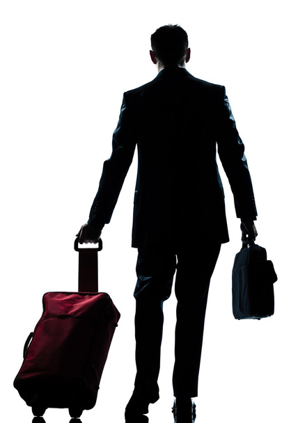 Business traveler man walking with suitcase rear view - Foto, immagini