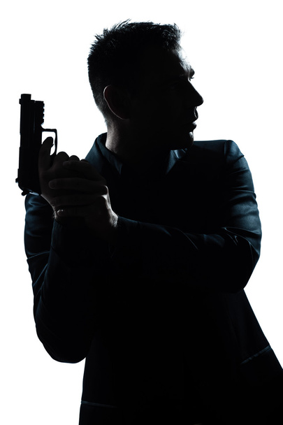 Silhouette man portrait with gun - Photo, image