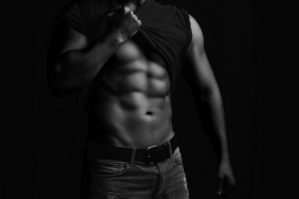 Muscular man with shirt on shoulder - Фото, зображення