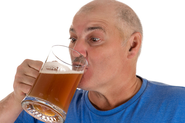 attractive man drinking beer from a mug - 写真・画像