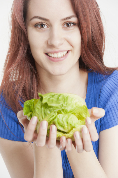 Nuori nainen pitää salaattia käsissään
 - Valokuva, kuva