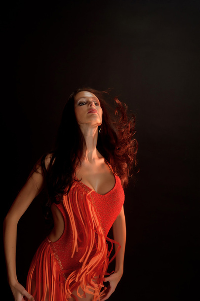 Beautiful dark-haired woman in a red dress - Фото, изображение