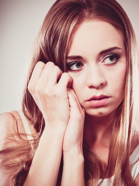 Young sad stressed woman closeup - 写真・画像