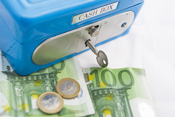 Stacks of euro coins and banknotes in a cash box - Photo, Image