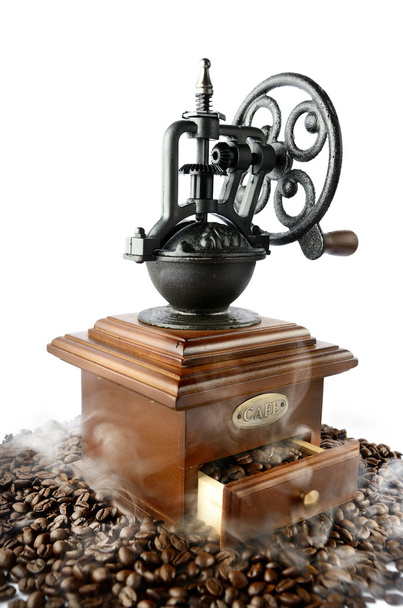 Vintage coffee grinder with baked coffee beans and smoke isolate - Photo, Image