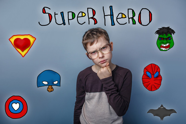 boy thinks his chin hand frowned superhero super power at the ph - Foto, afbeelding