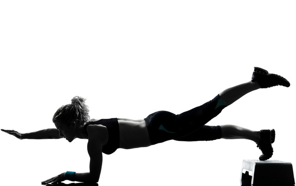 Woman exercising step aerobics - Photo, Image