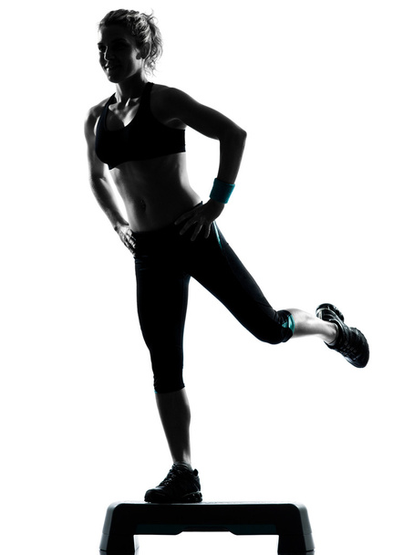 Woman exercising step aerobics - Фото, зображення