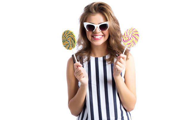 Woman in sunglasses holding lollipop. - Zdjęcie, obraz
