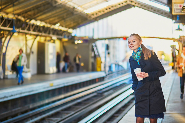 Beautiful young woman waiting for a train - Foto, imagen