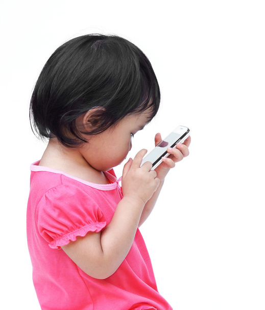 Asian kid playing with a smartphone - Foto, Bild