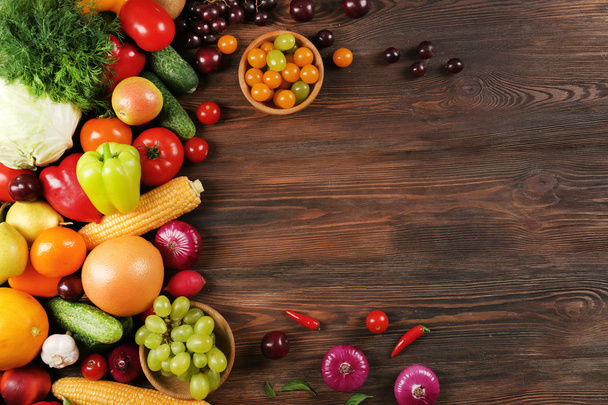 Heap of fruits and vegetables on wooden background - Foto, Bild