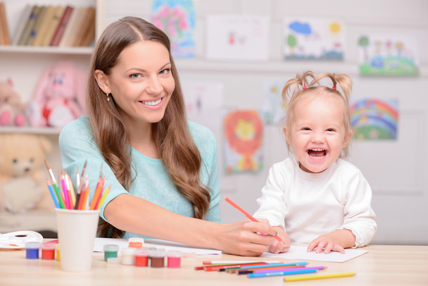 Cheerful woman is spending time with her child - Φωτογραφία, εικόνα