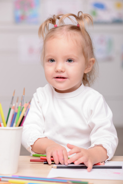 Cheerful small female child is drawing with joy - Fotoğraf, Görsel