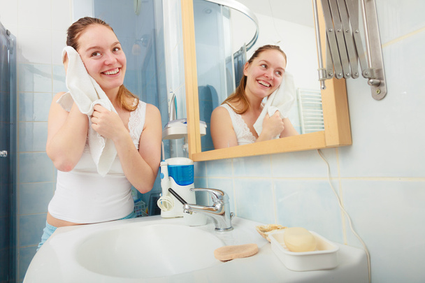 woman washing her face with clean water in bathroom - Photo, Image
