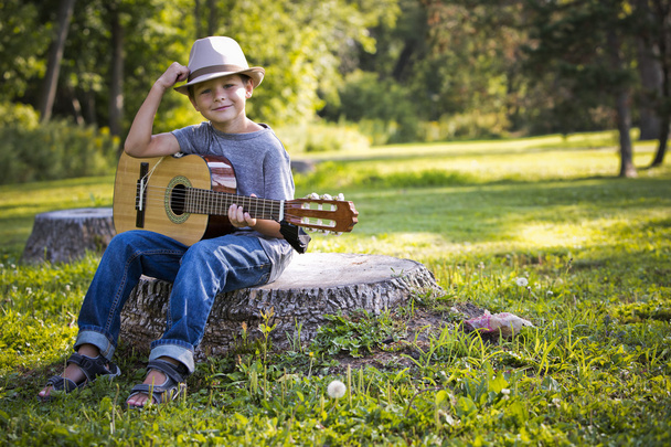 portrait of a little boy with guitar - Фото, изображение