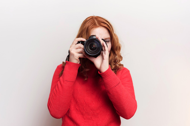 redhead woman learning to use camera - Photo, Image