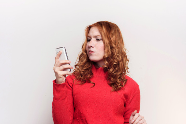 redhead woman using mobile phone - Fotó, kép