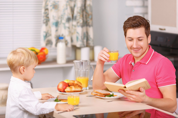 Father and his son are having fine breakfast. - Photo, Image