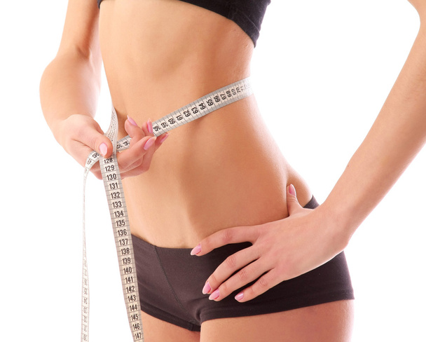 Woman measure her waist belly by metre-stick. - Foto, imagen