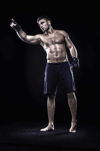 Mixed martial arts fighter isolated on black background - Фото, изображение