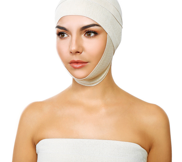 Young beautiful woman with an elastic bandage on her head, isolated on white - Foto, imagen