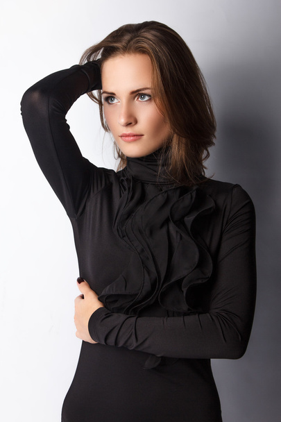 Brunette woman in black - Фото, изображение