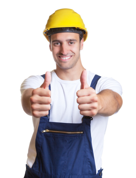 Happy latin construction worker showing both thumbs - Foto, Bild
