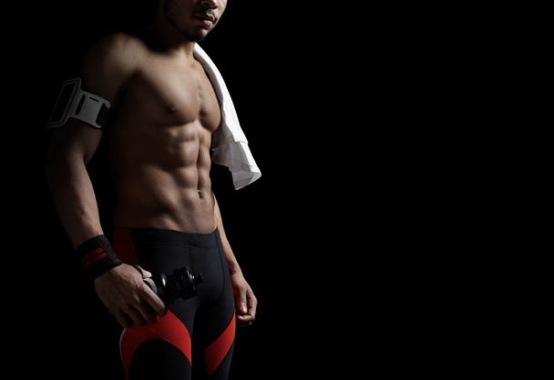 Athletic man on black background - Valokuva, kuva