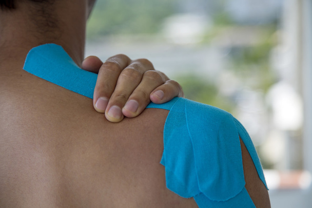 Adhesive bandage on shoulder - Фото, изображение