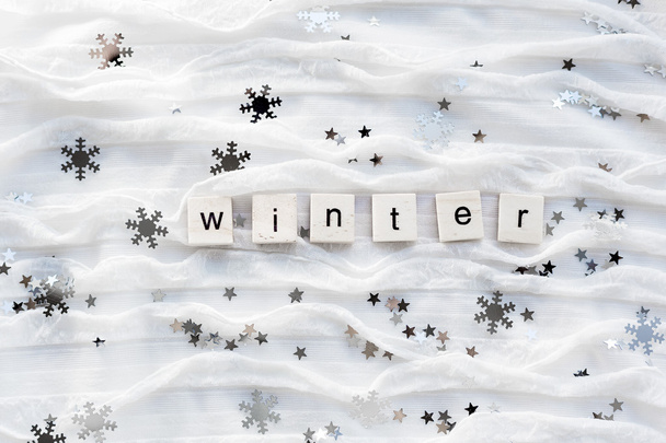 Winter background with decorative sparkling snowflakes and word WINTER. - Photo, Image