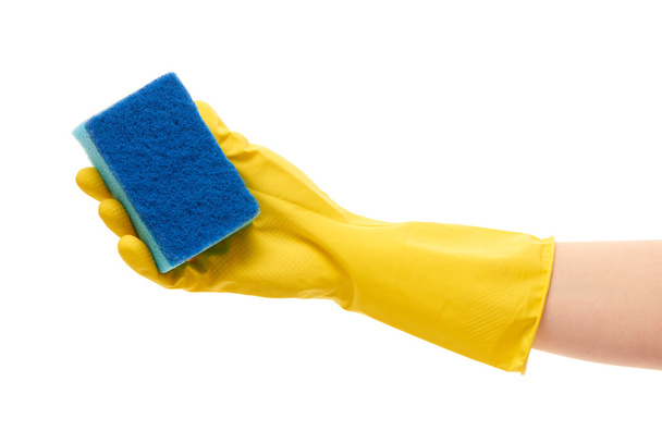 Female hand in yellow protective glove holding blue cleaning sponge - Foto, Imagem