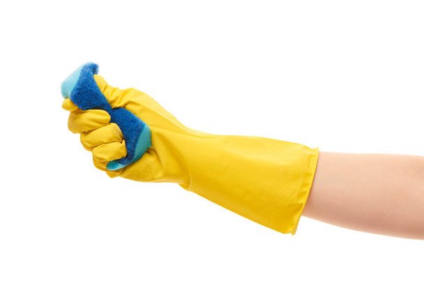 Female hand in yellow protective glove squeezing blue cleaning sponge - Foto, Bild