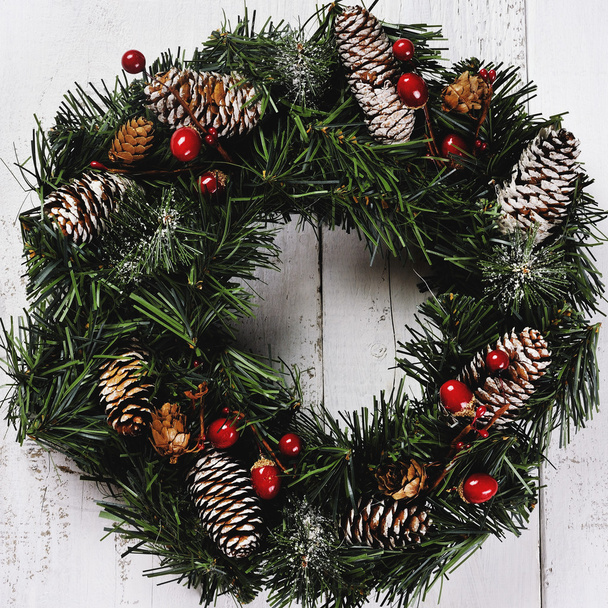 christmas wreath with pinecones on wooden background - Photo, Image