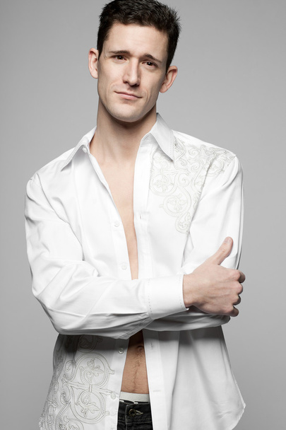 Handsome man in white shirt on gray. - Fotoğraf, Görsel