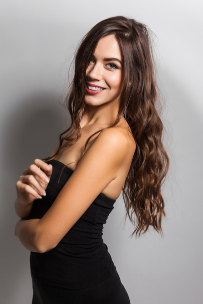 Student smiling brunette with white teeth on a white background - Fotografie, Obrázek