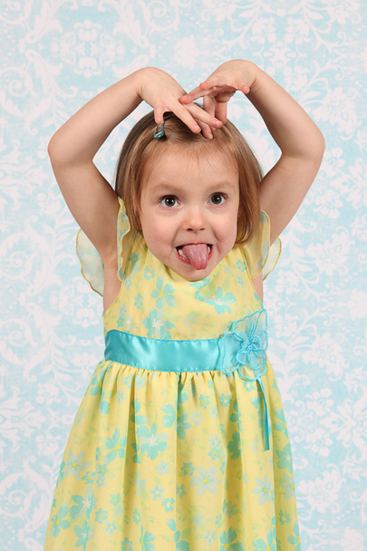 Adorable little girl making funny faces in studio - Φωτογραφία, εικόνα