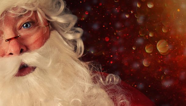 Closeup of Santa with a magical holiday background - Photo, Image