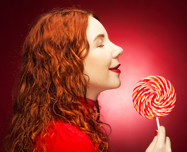 Pretty young woman holding lolly pop. - Фото, зображення