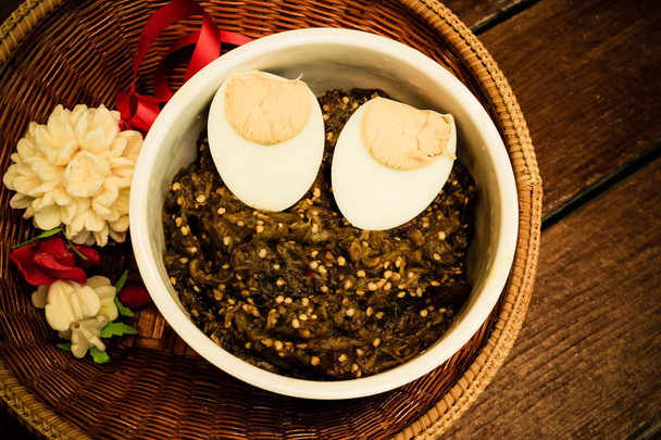 Thai food pound eggplant with boiled egg on wood table , vintage - Photo, Image