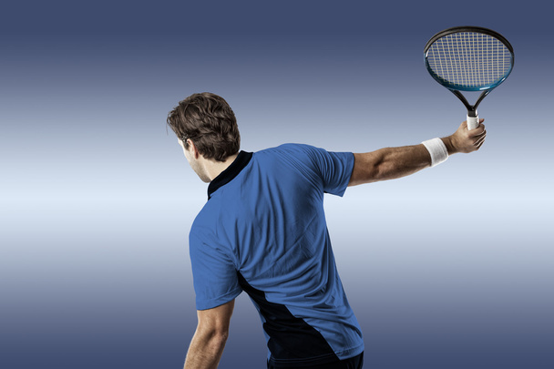 Tennis player with a blue shirt. - Zdjęcie, obraz