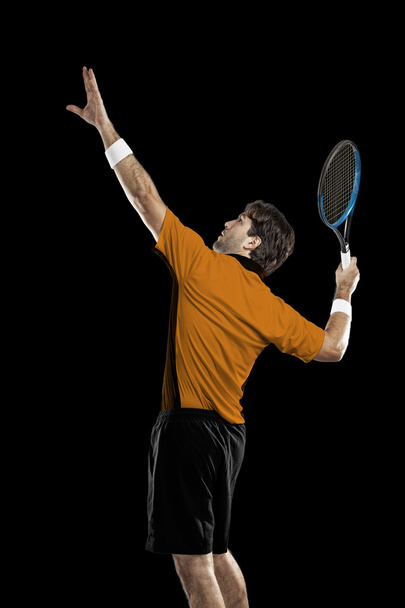 Tennis player with a orange shirt. - Zdjęcie, obraz